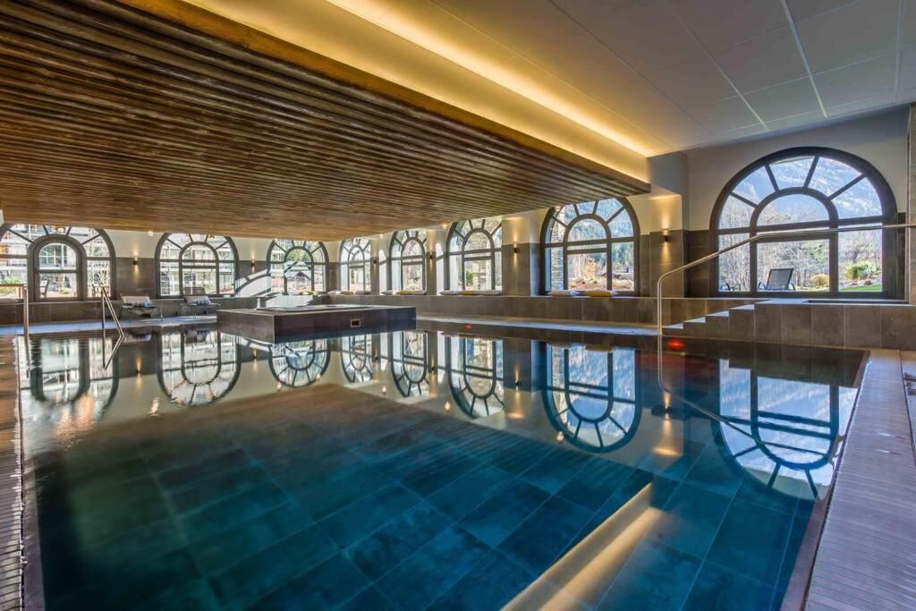 La piscine intérieure chauffée de la résidence, éclairée par une rangée de fenêtres en plein cintre
